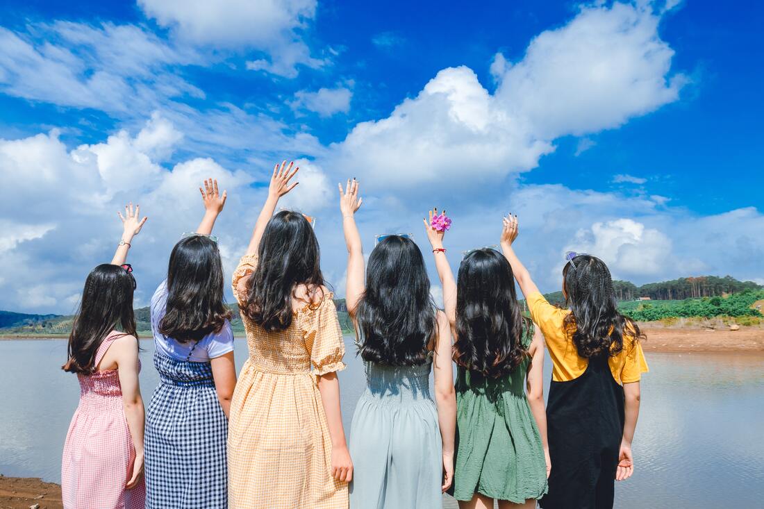 Group of girls reaching toward the sky